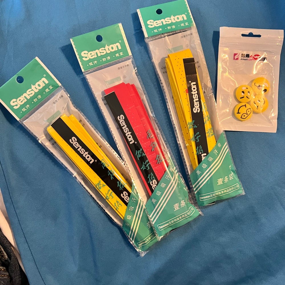 Three Tennis Racquet Grips and Four Vibration Dampeners